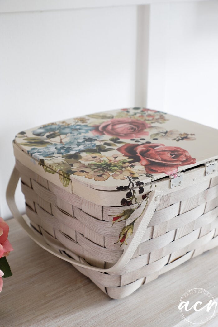 white basket with floral transfer on dresser with lamp