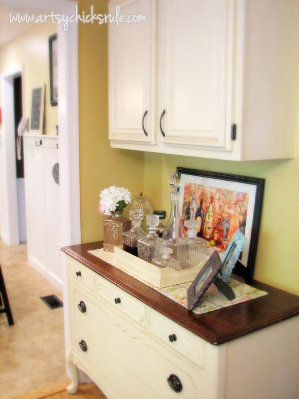 cream dresser with wood top and cabinet