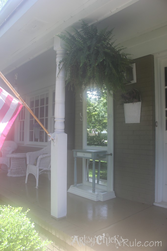 front porch with American flag, green fern and hall tree