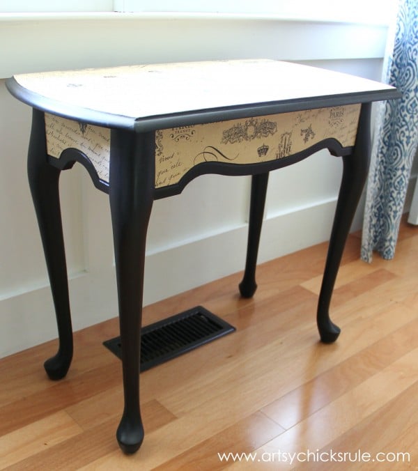 black painted table with tan colored french style tissue paper 