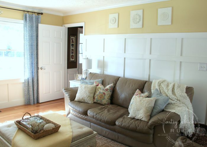 tan leather couch, ottoman and yellow walls