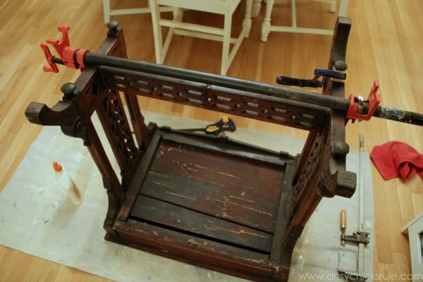 stained writing desk upside down with clamp