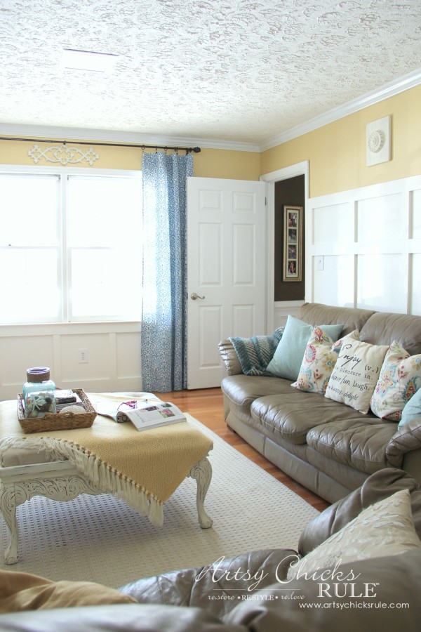 white wall with trim and yellow paint