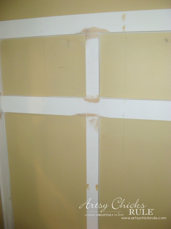 yellow wall with white boards