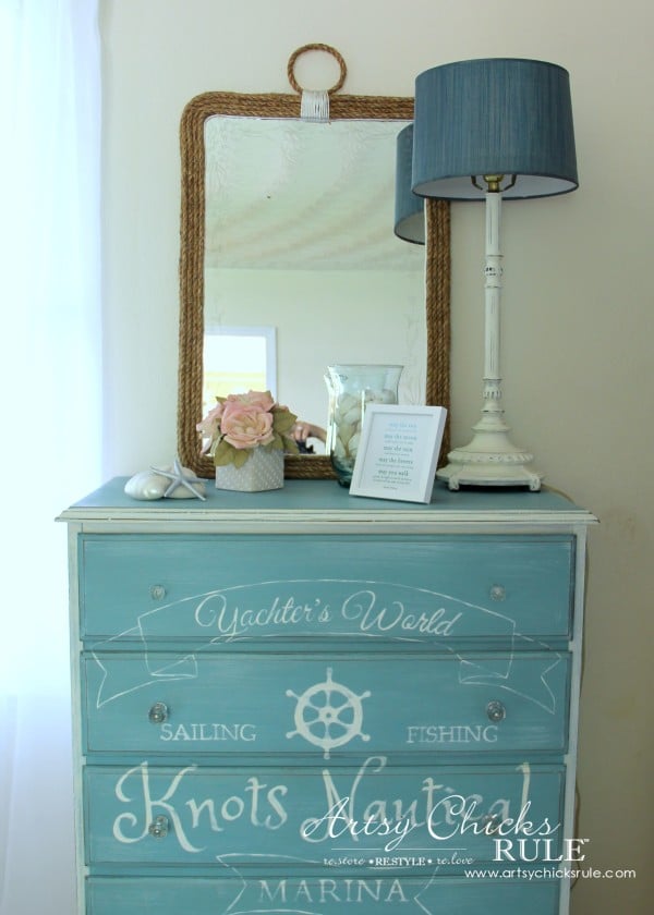 mirror on blue dresser with decor