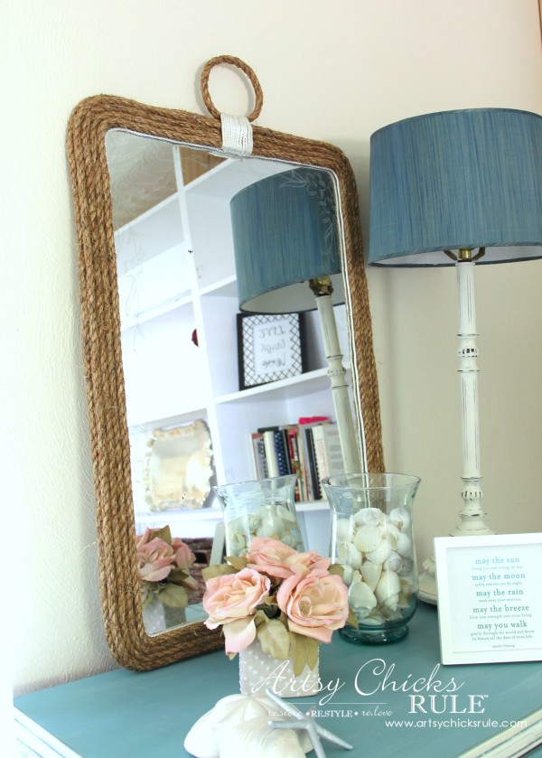 mirror on dresser with decor and lamp