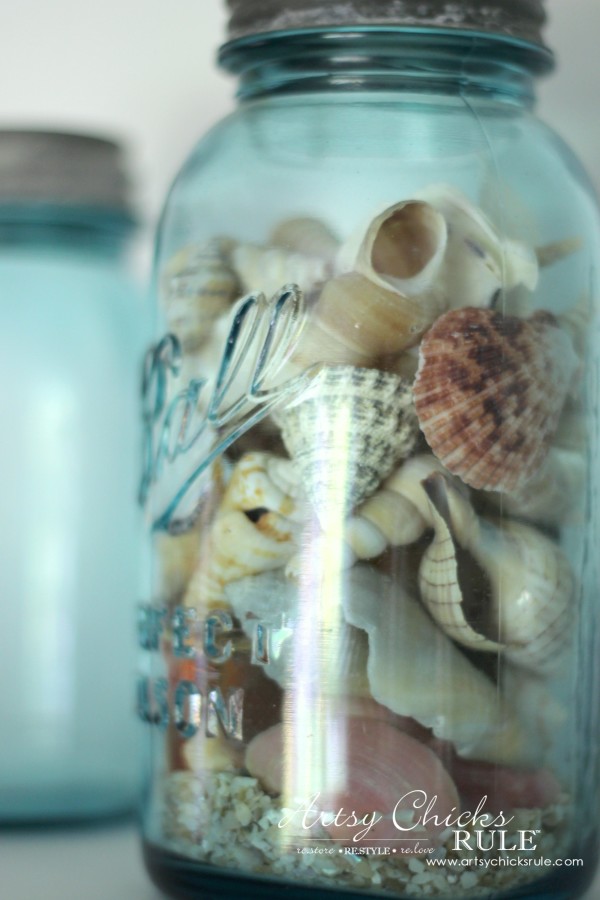blue mason jar filled with seashells