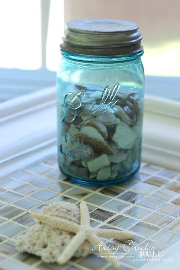 blue mason jar on top of tiled tray