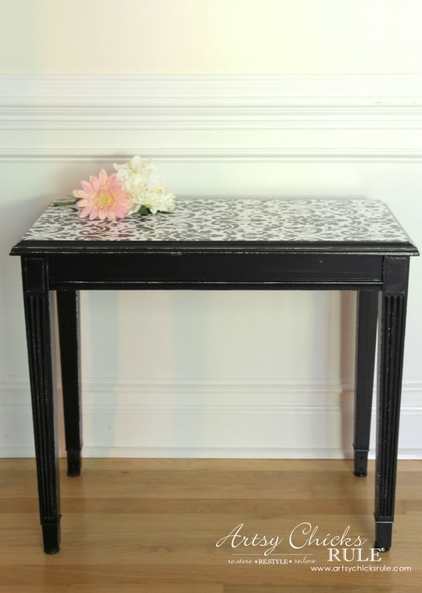 black small table with flowers on top