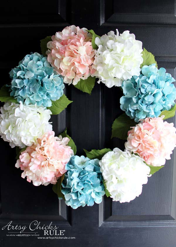 blue pink and white hydrangea wreath on black door