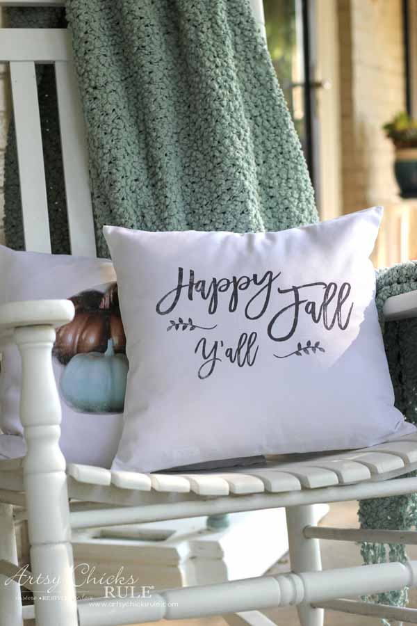 white pillow on white rocker with happy fall y'all lettering