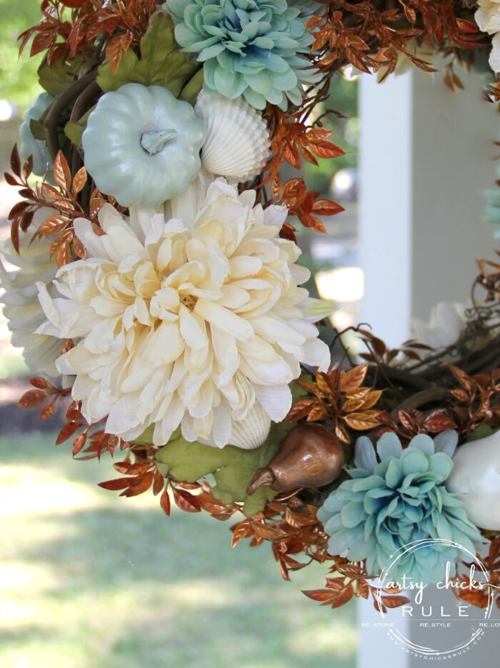 rust colored leaves ivory florals and tiny pumpkins on wreath