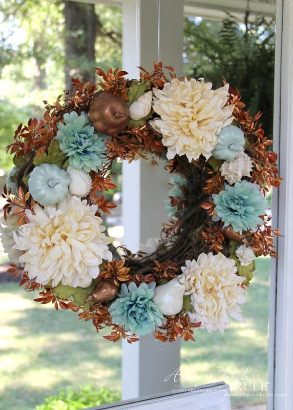 rust orange cream and aqua fall wreath hanging on mirror