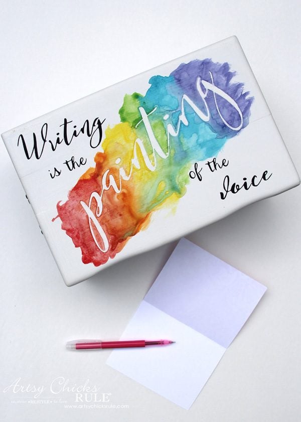 white box with rainbow and writing quote