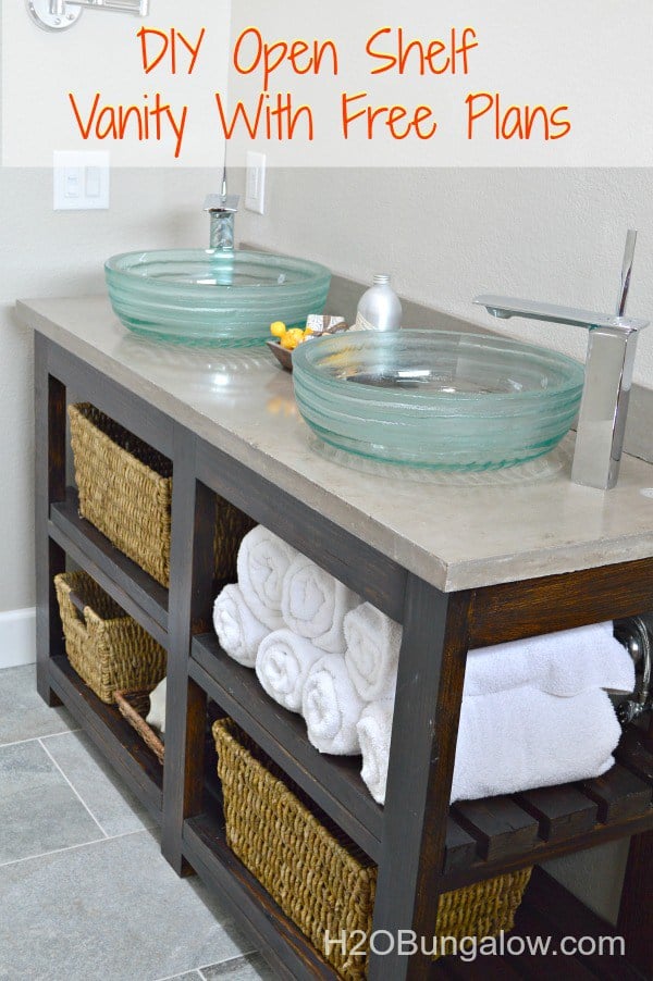 Open shelf vanity with clear glass sinks.