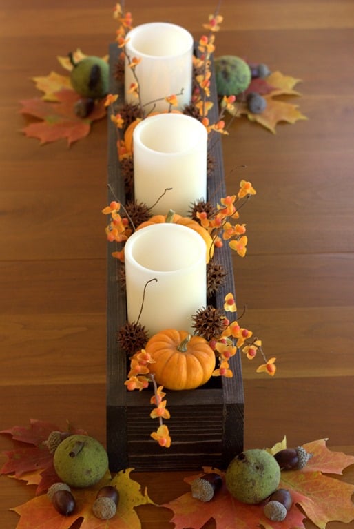 A wooden candle holder table centerpiece.