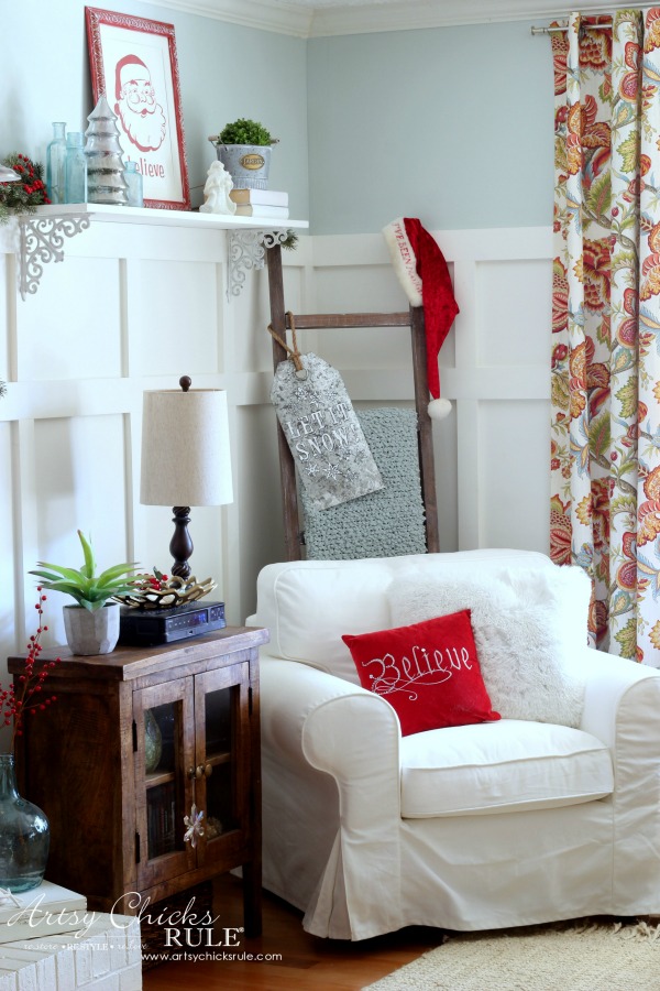 christmas decorated home with white chair and ladder