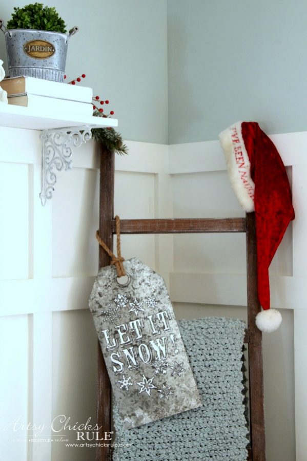 wood ladder with blanket and santa hat