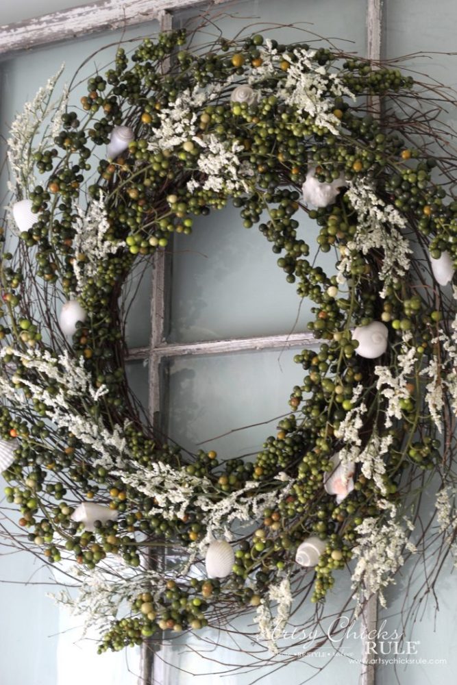 green berry wreath on old window