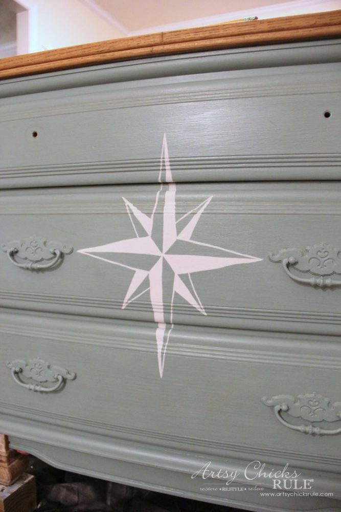 front of painted dresser with white painted compass rose