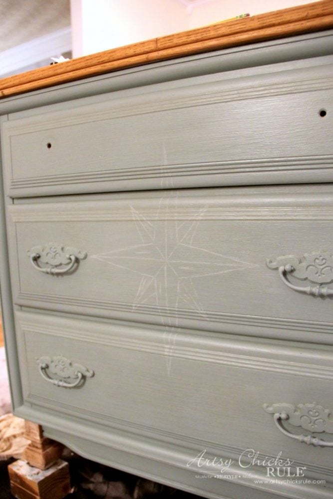 front of painted dresser with white drawer compass rose on front