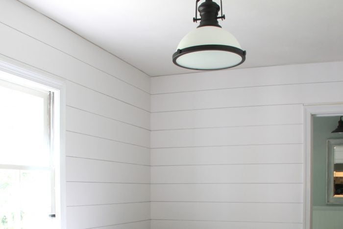 white wall and ceiling with bronze farm house style light fixture