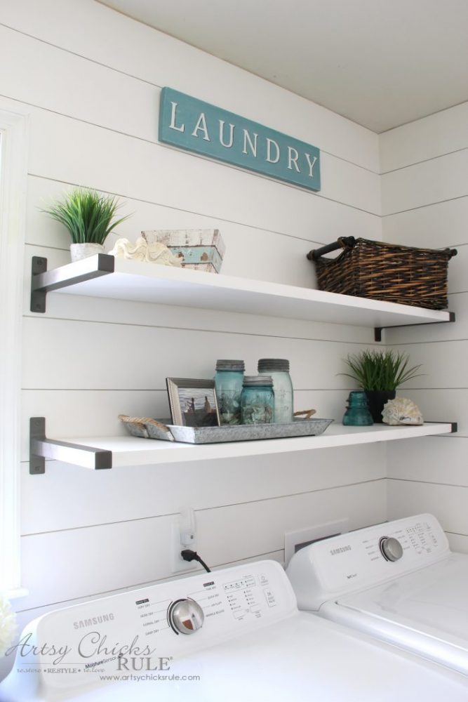 white shiplap wall with white shelves and decor