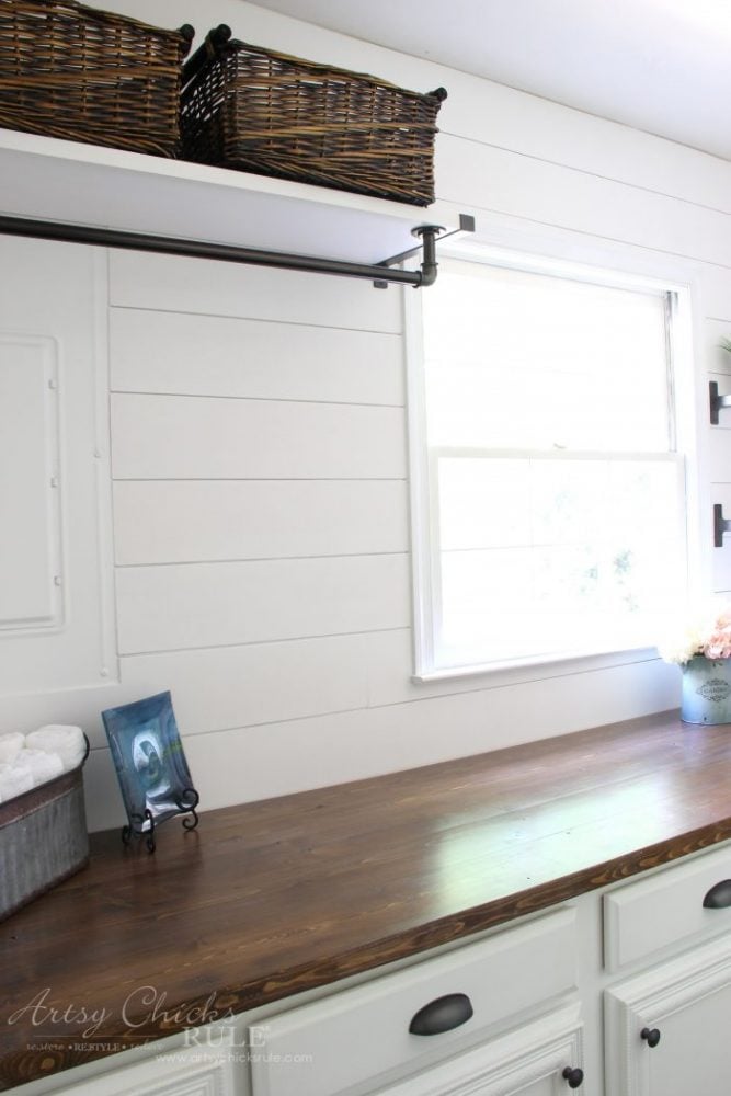 wood countertop white shiplap walls