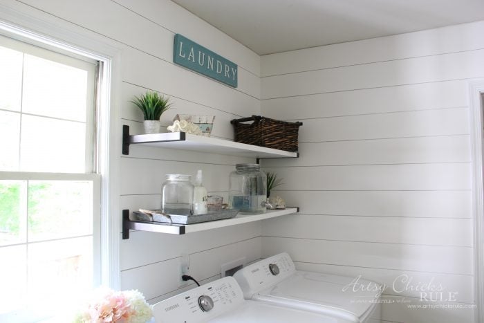 white laundry room with shelves and shiplap