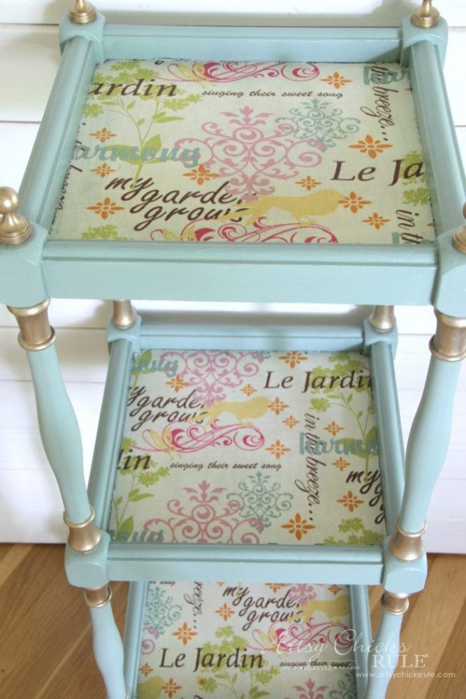 aqua tiered table with gold accents and colorful fabric decoupage