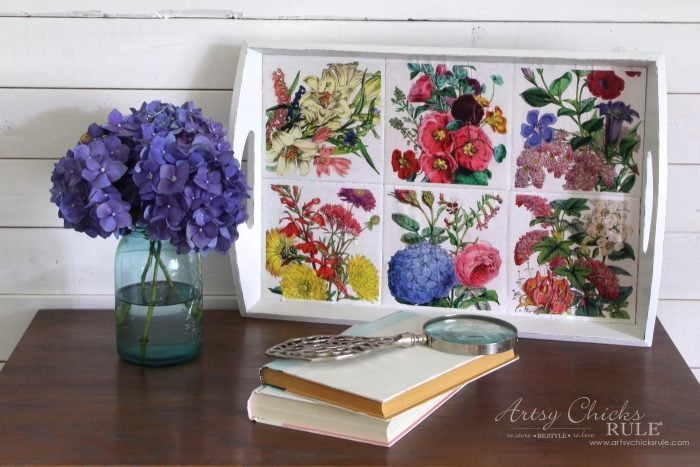 white tray with colorful flower printables on the tiles
