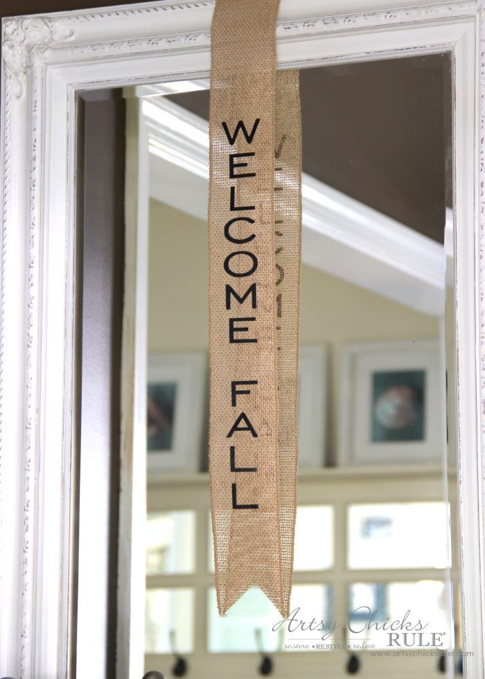 burlap strip hanging on mirror with welcome fall on it