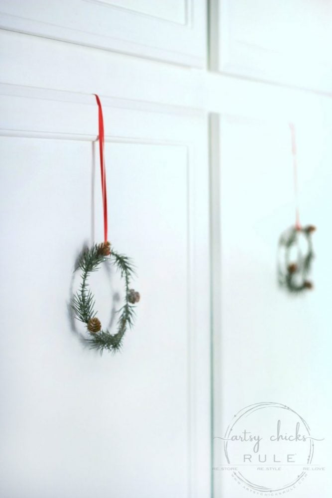 mini wreaths hanging on cabinet door