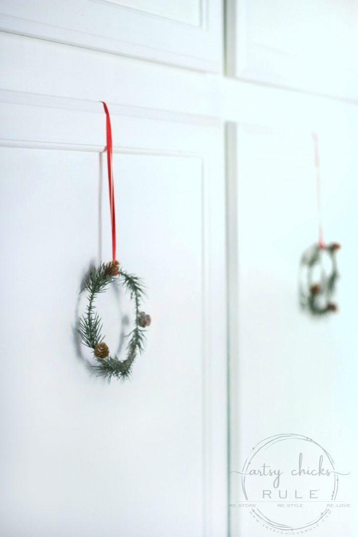 These wispy little DIY mini wreaths are so easy to make! And budget friendly too! artsychicksrule.com #miniwreaths #diywreaths #christmaswreaths #diyminiwreaths