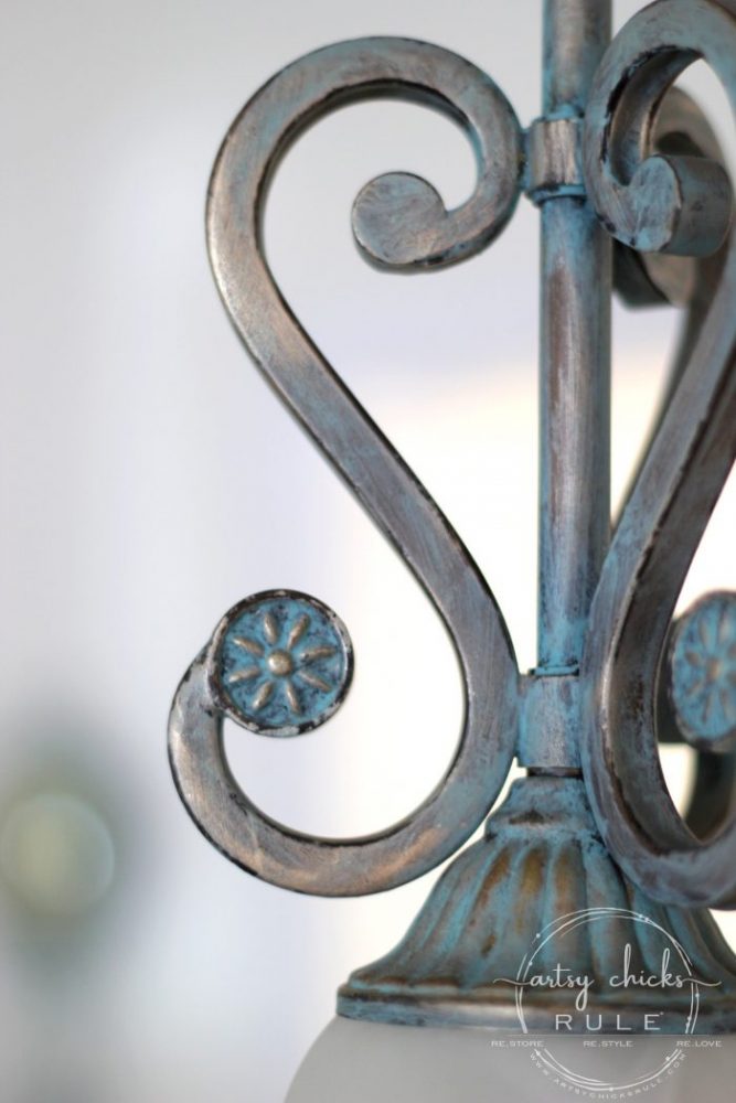metal scrollwork on light fixture that has been patina'd