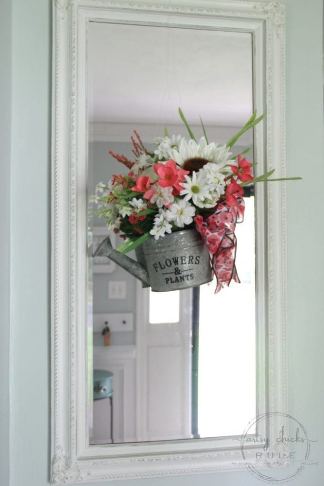 Unique Summer Wreath Idea!! Watering Can with Flowers to hang OR display on a shelf, etc. artsychicksrule.com #wateringcanwreath #uniquewreathideas #summerwreath #wildflowerwreath #wreathideas #summerdecor