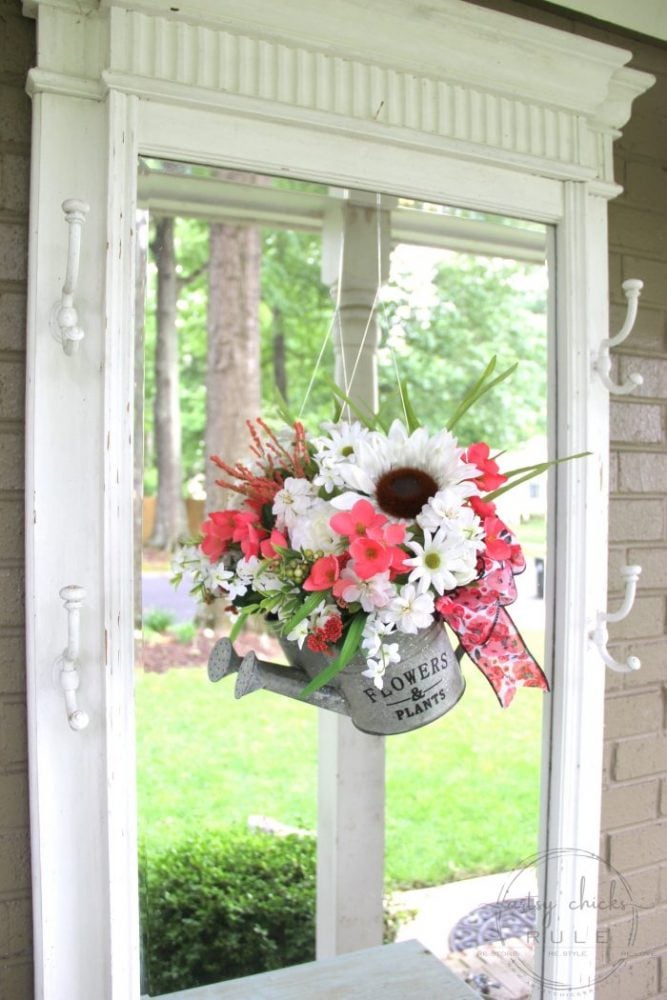 Unique Summer Wreath Idea!! Watering Can with Flowers to hang OR display on a shelf, etc. artsychicksrule.com #wateringcanwreath #uniquewreathideas #summerwreath #wildflowerwreath #wreathideas #summerdecor