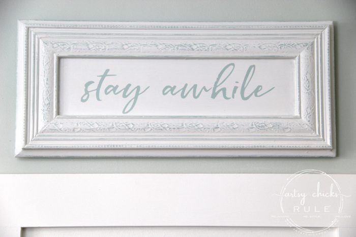 Make Your Own Stay Awhile Sign With This FREE Printable (on wall) artsychicksrule.com #repurposed #cabinetdoorideas #stayawhile #diysign #freeprintable #cabinetdoorrepurposed #silhouetteprojects