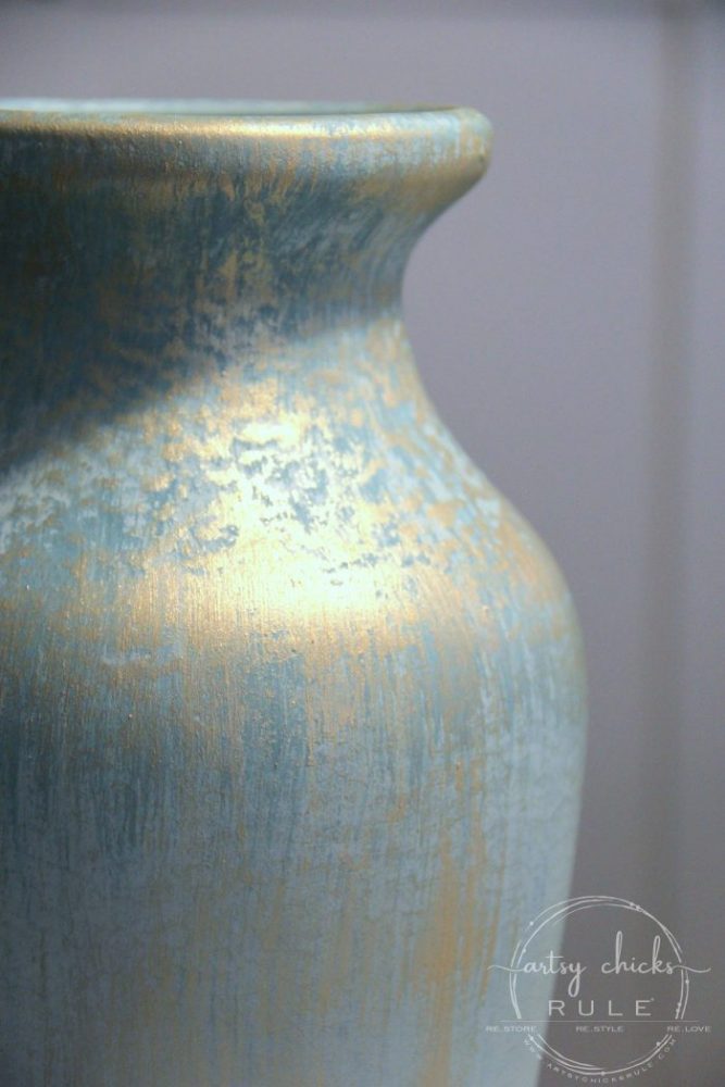 up close photo of aqua and turquoise vase with gold paint