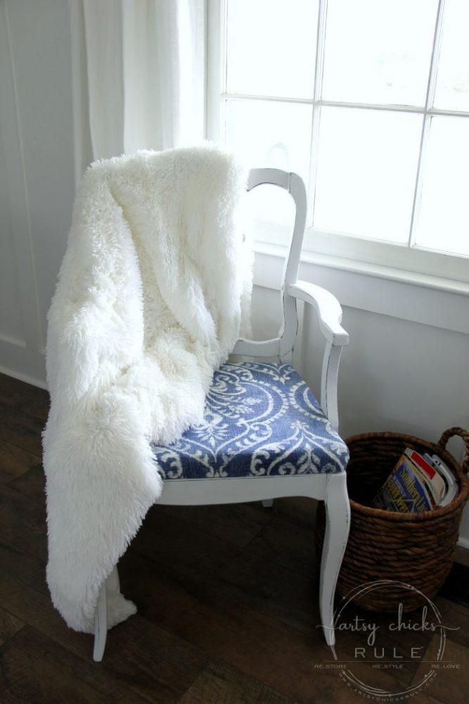 chair with white blanket and basket