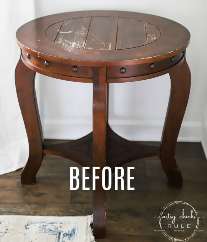 dark wood round table with rivets