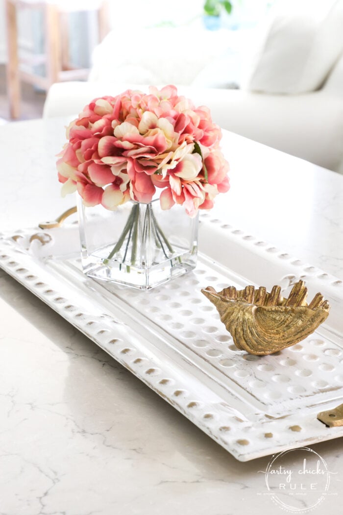 white painted metal tray with pink flowers on counter
