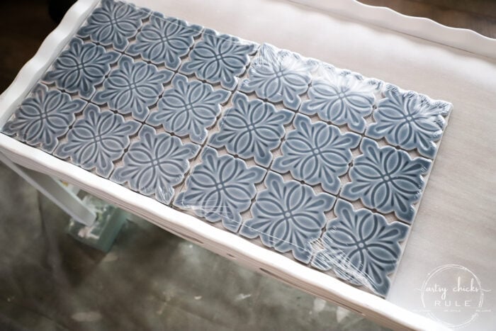 How To Tile A Table Top....easier than you think! Use this simple trick to tile all the things...furniture, decor and more! artsychicksrule.com #howtotile #tileatabletop #blueandwhitetile #furnituremakeover #paintedfurniture