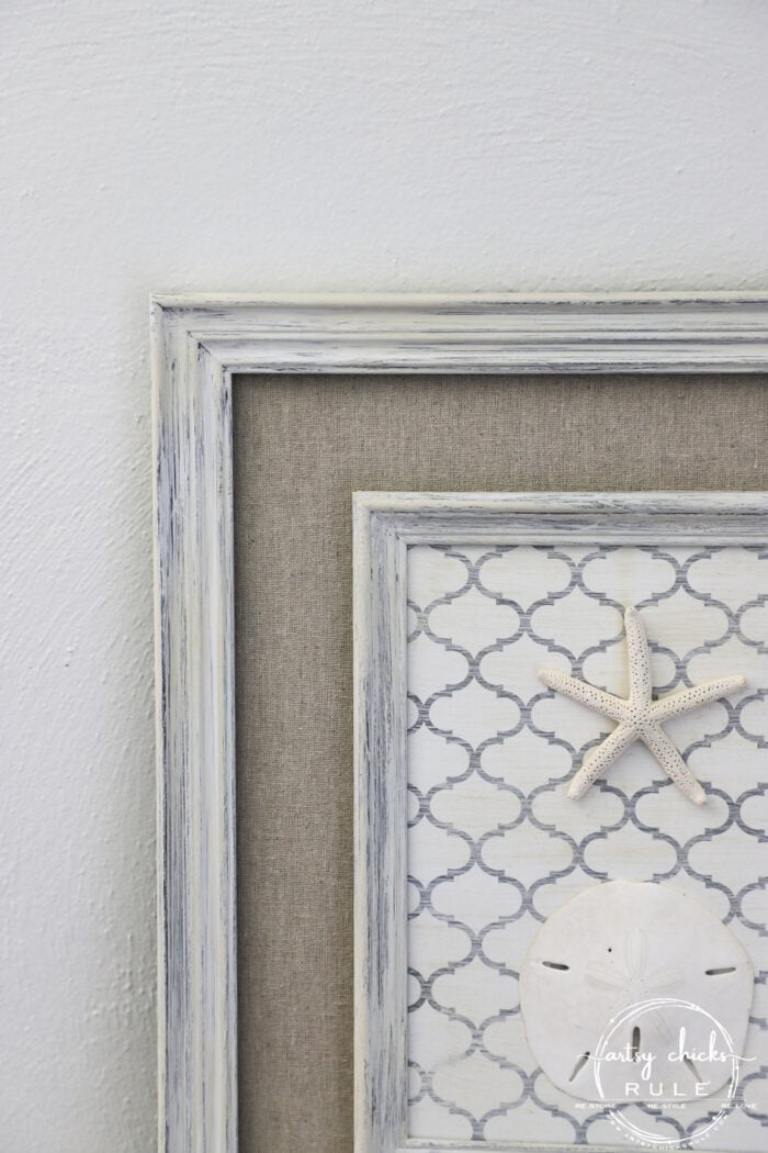 Shelf liner paper, paint and a few sea finds are all you need to transform a simple thrift store find into beautiful new starfish wall decor! artsychicksrule.com #starfishwalldecor #coastalwallart #coastaldecor #coastalhome 