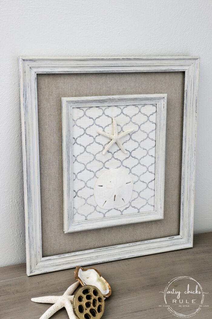 Shelf liner paper, paint and a few sea finds are all you need to transform a simple thrift store find into beautiful new starfish wall decor! artsychicksrule.com #starfishwalldecor #coastalwallart #coastaldecor #coastalhome 