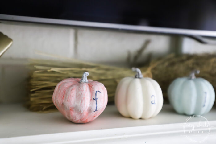 small pumpkins on a mantel