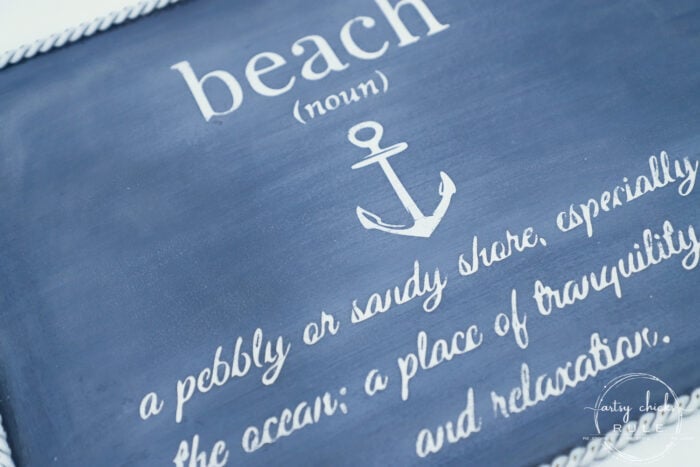 This $3 thrift store wall decor got an entirely new look with paint and a free printable! This fun metal beach sign is budget-friendly decor at its best! artsychicksrule.com #metalbeachsign #beachdecor #coastaldecor #freeprintable 