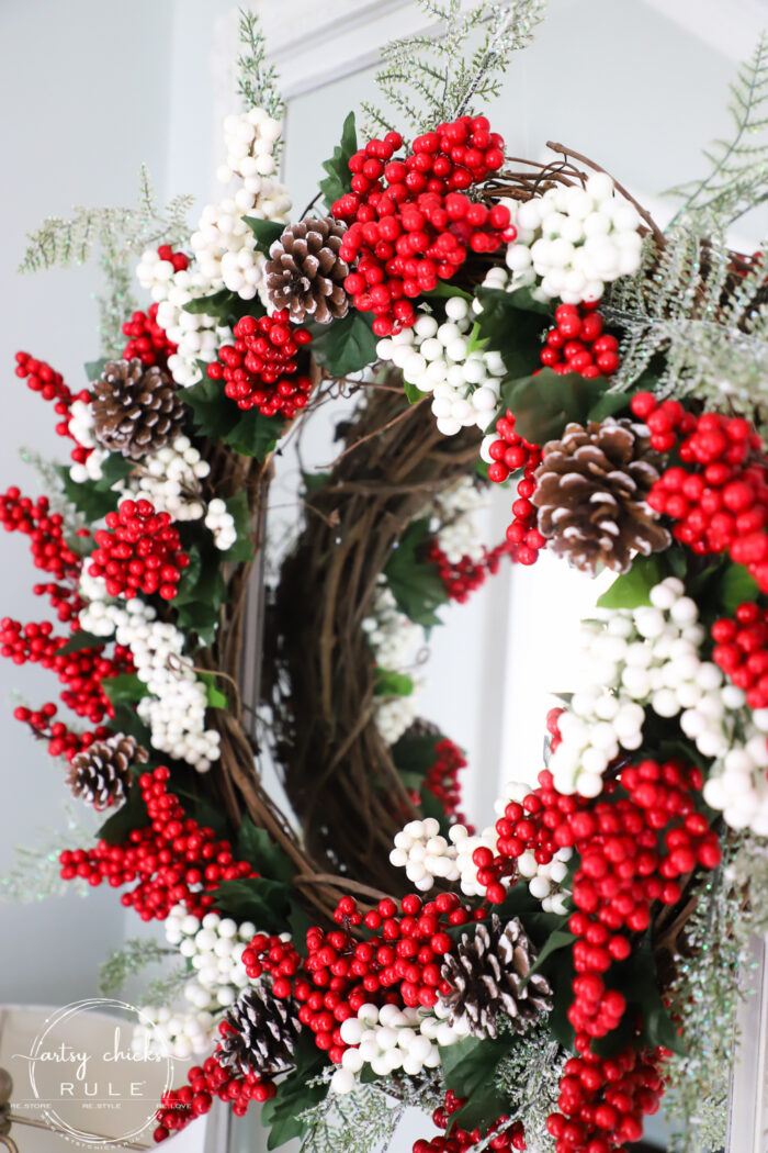 Fun and festive DIY red berry wreath made with items found at the Dollar Store! Budget friendly (and oh so simple) holiday decor! artsychicksrule.com #redberrywreath #diychristmaswreath #dollarstorecrafts #dollarstorewreath