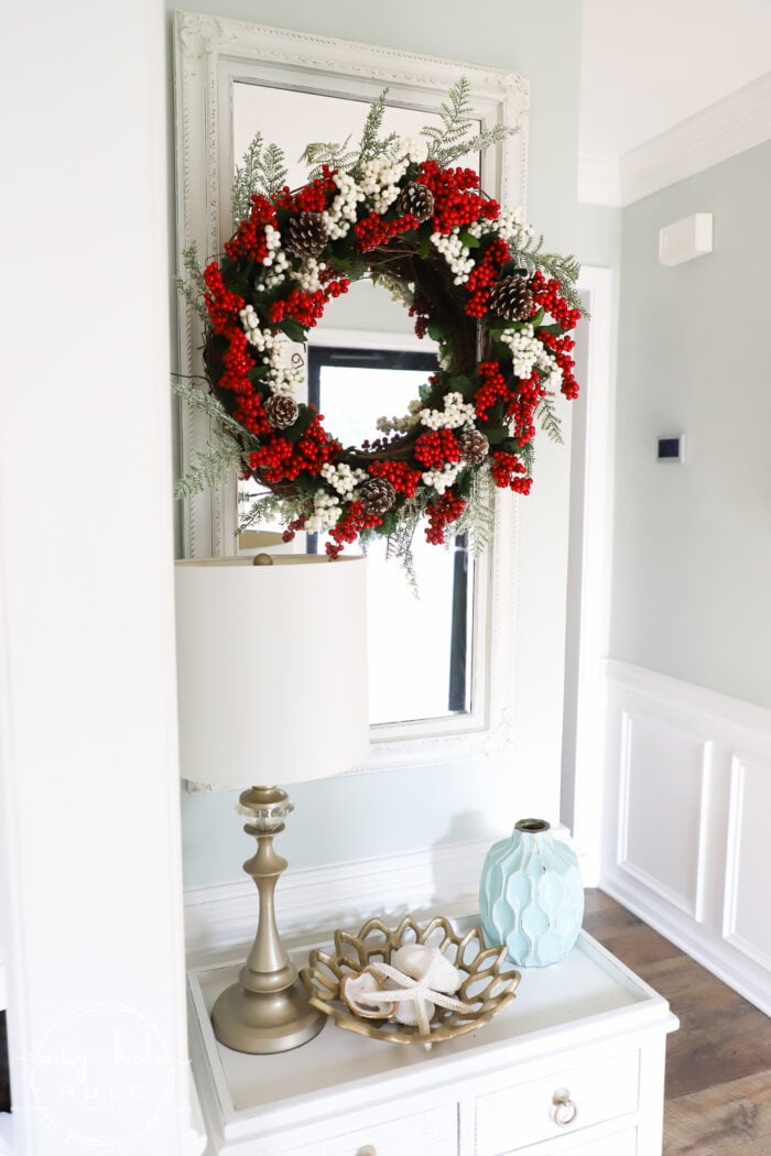 Fun and festive DIY red berry wreath made with items found at the Dollar Store! Budget friendly (and oh so simple) holiday decor! artsychicksrule.com #redberrywreath #diychristmaswreath #dollarstorecrafts #dollarstorewreath