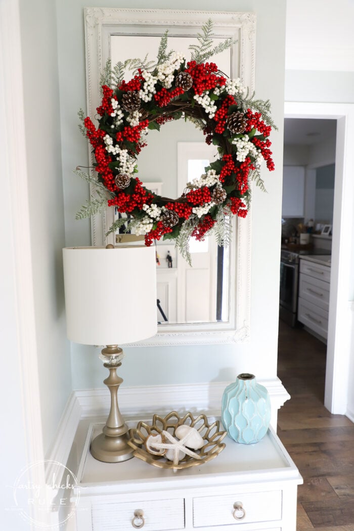 Fun and festive DIY red berry wreath made with items found at the Dollar Store! Budget friendly (and oh so simple) holiday decor! artsychicksrule.com #redberrywreath #diychristmaswreath #dollarstorecrafts #dollarstorewreath